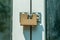 Locked golden modern steel safety or security padlock on the entrance doors close up