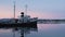 Locked off view Of HMS Justice in water against evening sunset in Ushuaia