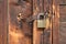 Locked padlock securing wooden door