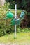 Locked public watering cans on a metal cross in the cemetery