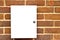 Locked white cupboard on a brick wall