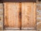 Locked wooden gate in stone wall, texture