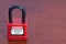 Lockout Padlock red color on wood background