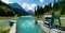 Locks and weir of a dam on a turquoise colored mountain lake water reservoir