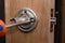 locksmith carpenter fix knob on wooden door by screwdriver for home service reparation