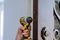 Locksmith hand holds the screwdriver in installing new house door lock