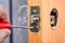 Locksmith secures latch plate for interior door knob