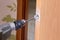 Locksmith use flat bit to wood when drilling hole for latch