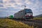 Locomotive freight train driving in the countryside