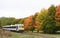 Locomotive traveling in the wild canadian forest in autumn
