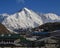 Lodges in Gokyo and snow covered mount Cho Oyu. Spring scene in