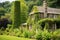 a lodges sturdy stone chimney amongst greenery