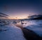 Lofoten islands, Norway. Mountains, ice with snow and clouds during sunset. Evening time. Winter landscape near the ocean.