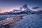 Lofoten islands, Norway. Mountains, ice with snow and clouds during sunset. Evening time. Winter landscape near the ocean.