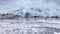 Lofoten islands, Norway. Rocky coast of fjord in winter with snow and ice.