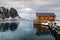 Lofoten islands, Norway, traditional fishing house in a fishing village in winter, reflection in water.