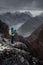 Lofoten Islands, Polar, Norway, a man stands on top and takes a photo on his mobile phone