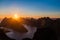 Lofoten midnight sun over sharp mountains of Moskenesoya seen from Munken peak summit, sunset and sunrise combined, Reine, Lofoten