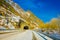 LOFOTEN, NORWAY, APRIL, 10, 2018: View of frozen street with an informative sign at the enter of a tunnel in Skjelfjord