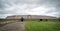 Lofotr Viking museum reconstructed longhouse with dramatic cloudy sky.