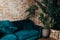 Loft brick red wall sofa aqua turquoise blue big huge flower in a pot. Interior design