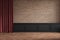 Loft empty interior with brickwall, red curtain, moldings and wooden floor.