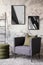 Loft and indiustral living room interior with mock up poster frame, stylish gray armchair, bottle green pillows, modern pouf,