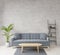 Loft style living room with raw concrete ,wooden floor,sofa,image for copy space or mock up