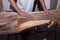 Loft table with epoxy resin in the workshop. black resin with stones inside. hands of the creator.