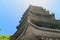 Log angle view of pagoda roofs against blue sky