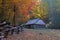 Log barn and split rail fence in mountain pasture