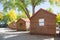 Log cabin in campground with autumn tree.