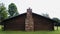 Log Cabin with Cobblestone and Brick Fireplace Chimney