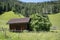 Log cabin in the Dolomites, fields and mountains. Alpine arch. Alps. Chalet. Italy