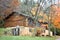 Log Cabin in Fall with Stone Foundation