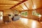 Log cabin house interior. Living room with fireplace and leather