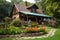 log cabin house with wrap-around porch and flower garden