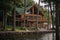 log cabin house with wrap around porch, overlooking lake