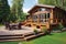a log cabin with a large front deck, outdoor furniture in view
