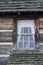 Log cabin window with candle