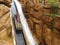 Log flume ride steep drop into artificial canyon with waterfall speed blur