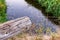 Log hanging over edge of stream