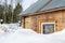 Log house covered with snow in forest