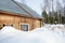 Log house covered with snow in forest