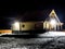 Log house on a winter evening on a slightly snow-covered building plot