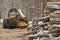 Log or Logging Skidder with Freshly Harvested and piled timber logs