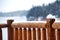 Log railing gathering snow on a cold winter day