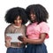 Logged into a buzzing social life. Studio shot of two young women using a digital tablet against a white background.