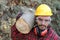 Logger holding heavy trunk in the forest