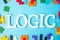 LOGIC text with colorful wood puzzle pieces, geometric shape block on blue background. Concepts of logical thinking, Conundrum,